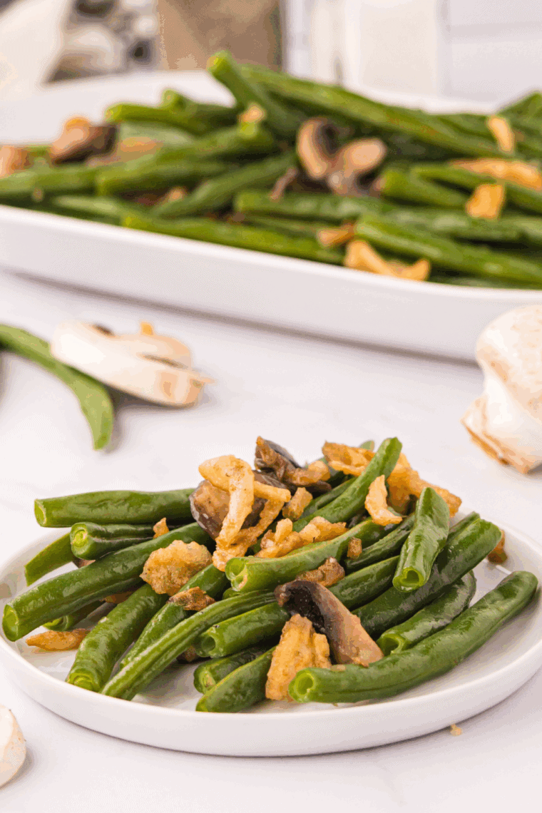 Green beans sautéing in a cast iron skillet with garlic and butter.