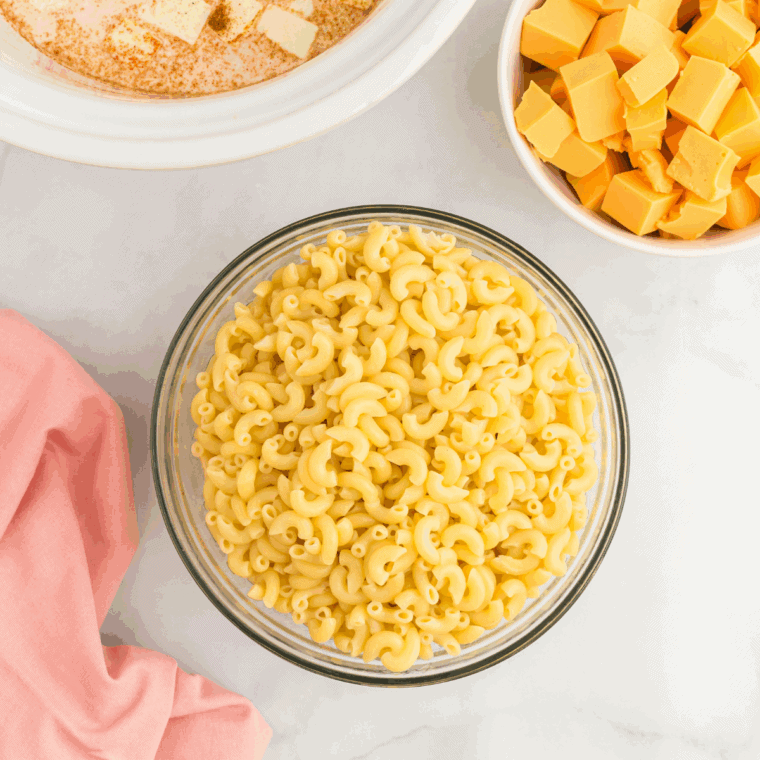 Boiling elbow macaroni in salted water until just al dente in a pot.