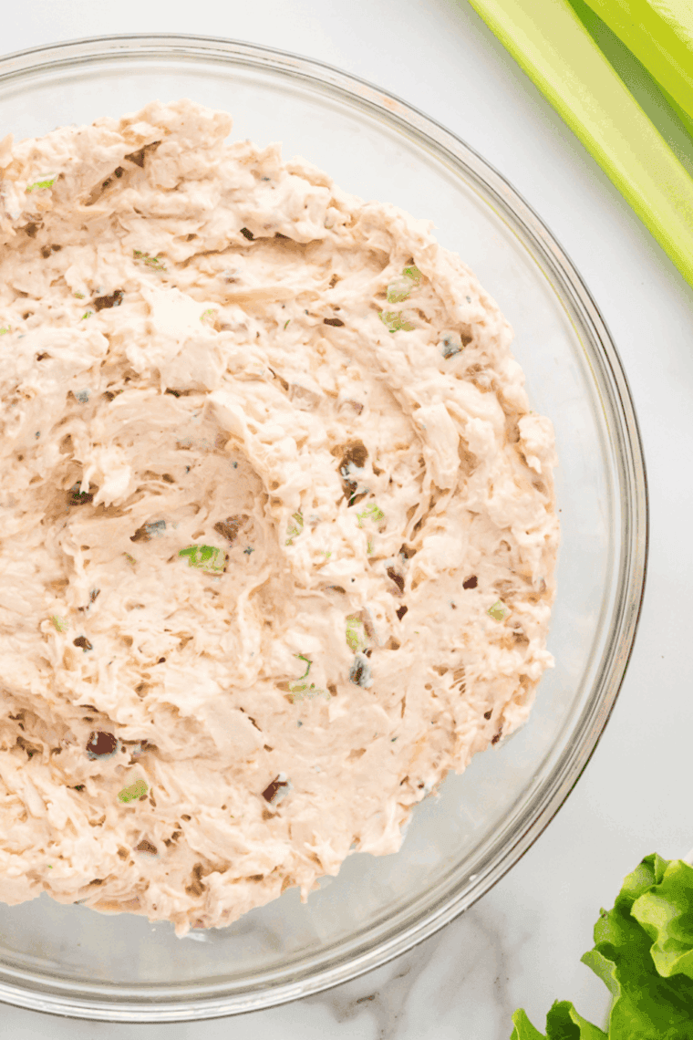 Shredded or chopped cooked chicken in a bowl, ready for mixing.
