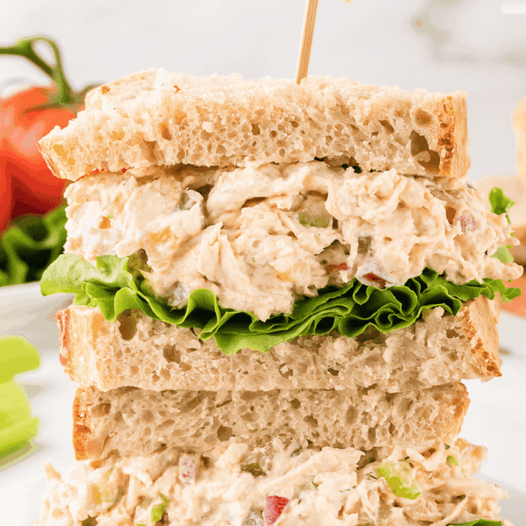 Adding shredded chicken to the creamy mixture, combined and ready to chill before serving.