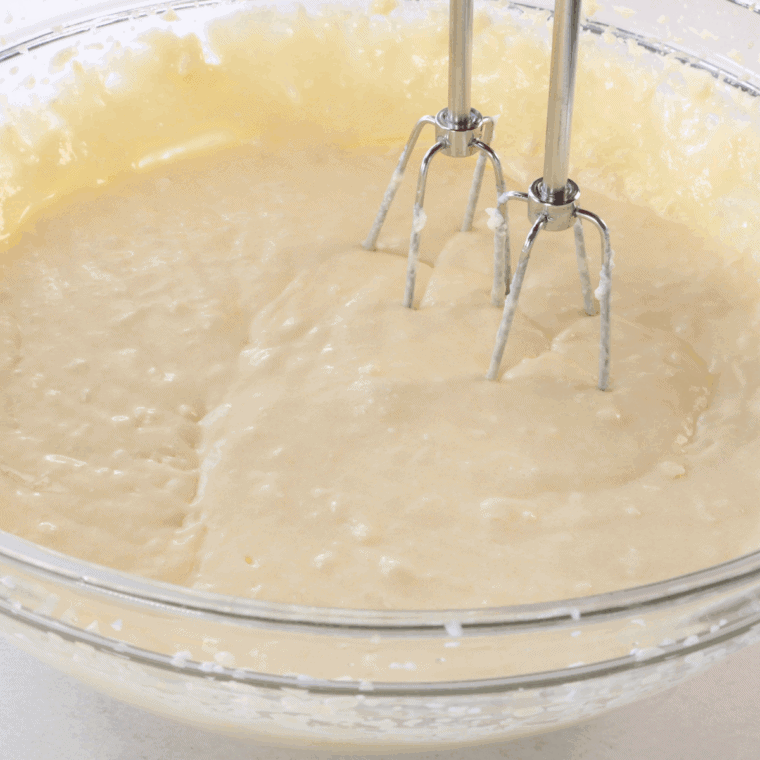 Whisking flour, baking powder, and salt in a separate bowl to combine dry ingredients
