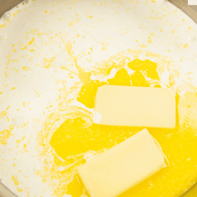 Unsalted butter melting in a medium saucepan over medium heat.