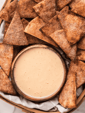 Creamy dip served in a bowl alongside crunchy cinnamon sugar pita chips.