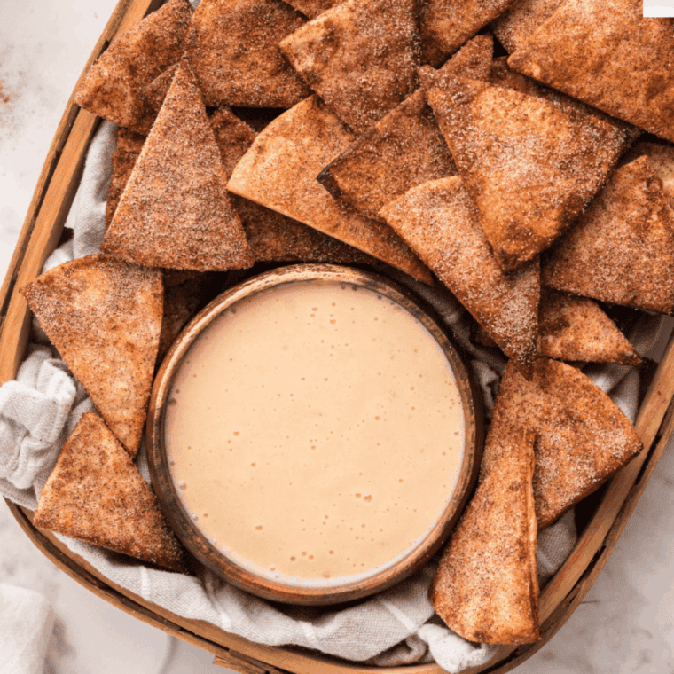 Creamy dip served in a bowl alongside crunchy cinnamon sugar pita chips.