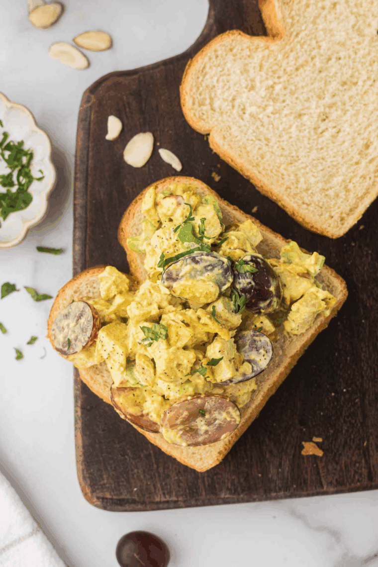 Plate of Easy Ina Garten's Curried Chicken Salad Recipe in sandwich form.