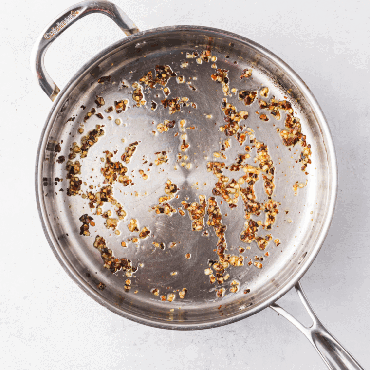 Sautéing chopped onions and garlic in olive oil in a skillet until fragrant and translucent.