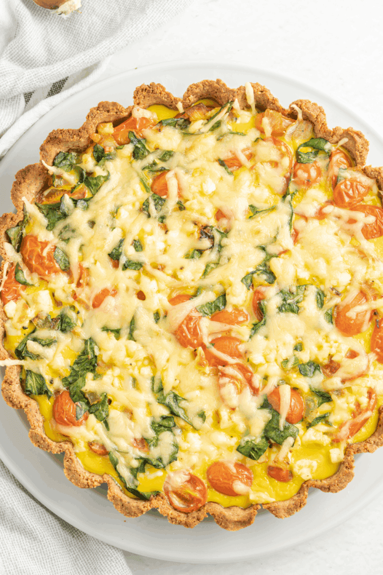 Golden-baked quiche cooling on a counter before slicing and serving.