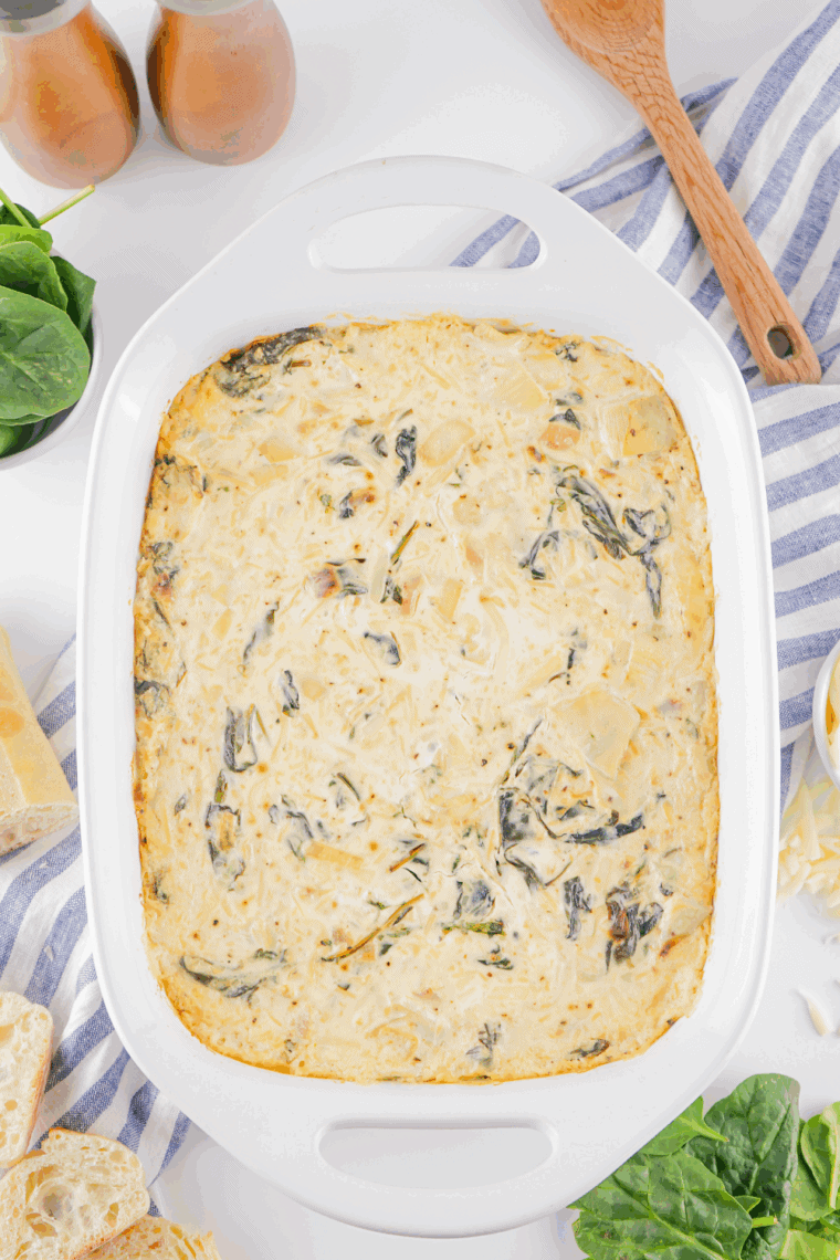 A bowl of Creamy Lipton Onion Soup with Spinach Dip served with crackers and fresh vegetable dip.