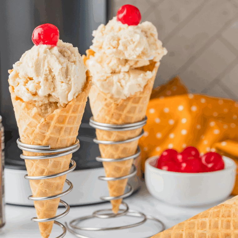 Butterbeer ice cream served in a bowl, topped with whipped cream, caramel drizzle, and a sprinkle of cinnamon, ready to enjoy.