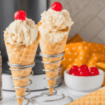 Creamy Butterbeer Ice Cream in a bowl with whipped cream topping