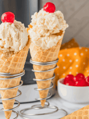 Creamy Butterbeer Ice Cream in a bowl with whipped cream topping