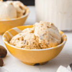 Creamy Ninja Creami Butterfinger Ice Cream topped with crushed Butterfinger candy pieces in a bowl.