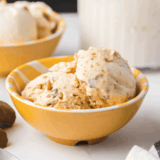Creamy Ninja Creami Butterfinger Ice Cream topped with crushed Butterfinger candy pieces in a bowl.