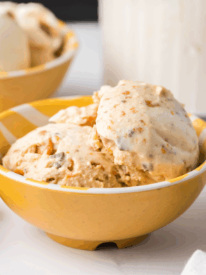 Creamy Ninja Creami Butterfinger Ice Cream topped with crushed Butterfinger candy pieces in a bowl.