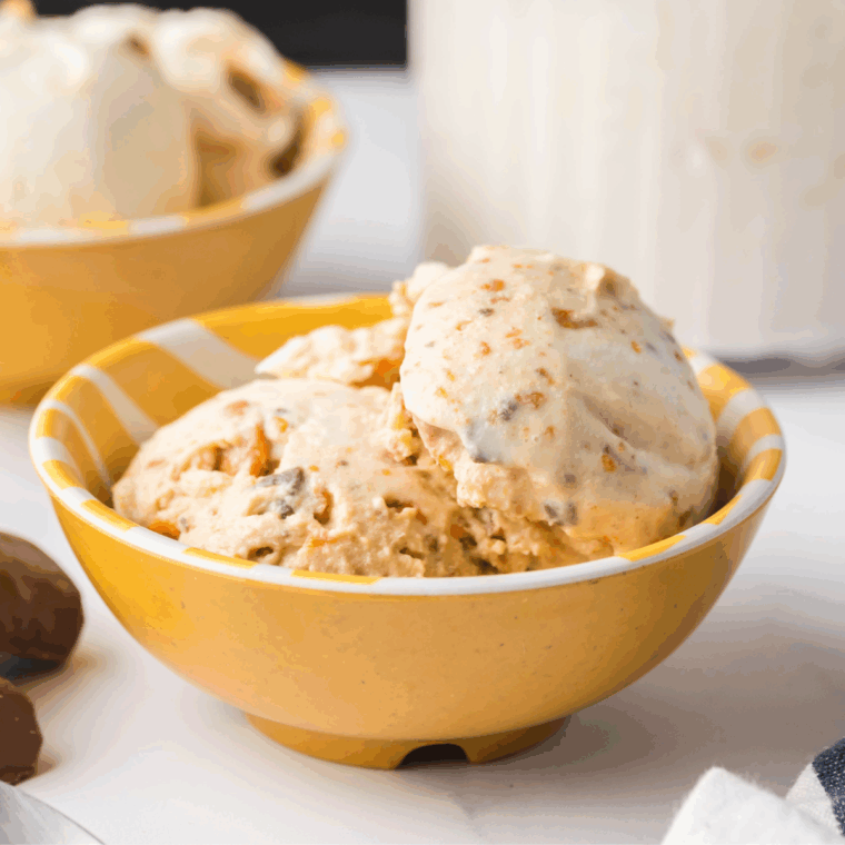 Creamy Ninja Creami Butterfinger Ice Cream topped with crushed Butterfinger candy pieces in a bowl.