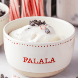 Bowl of creamy peppermint bark ice cream with chocolate chunks and crushed peppermint on top, ready to serve.