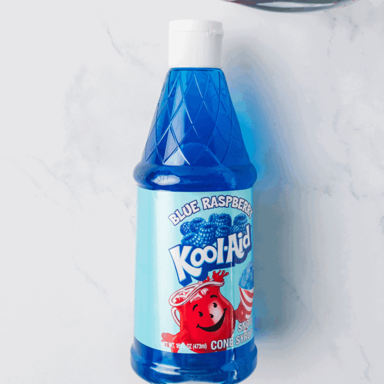 Ingredients needed for Easy Ninja Slushi Blue Raspberry Slush on kitchen table.