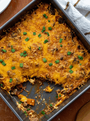 Slice of Pioneer Woman’s Cheeseburger Pie topped with melted cheese and served on a white plate.