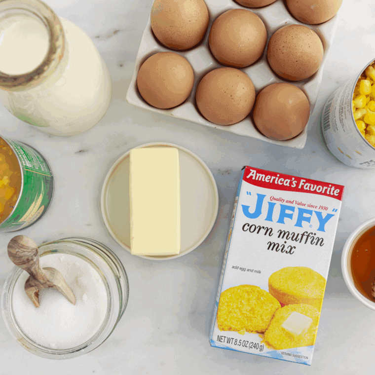 Ingredients needed for Easy Pioneer Woman's Corn Casserole Recipe on kitchen table.