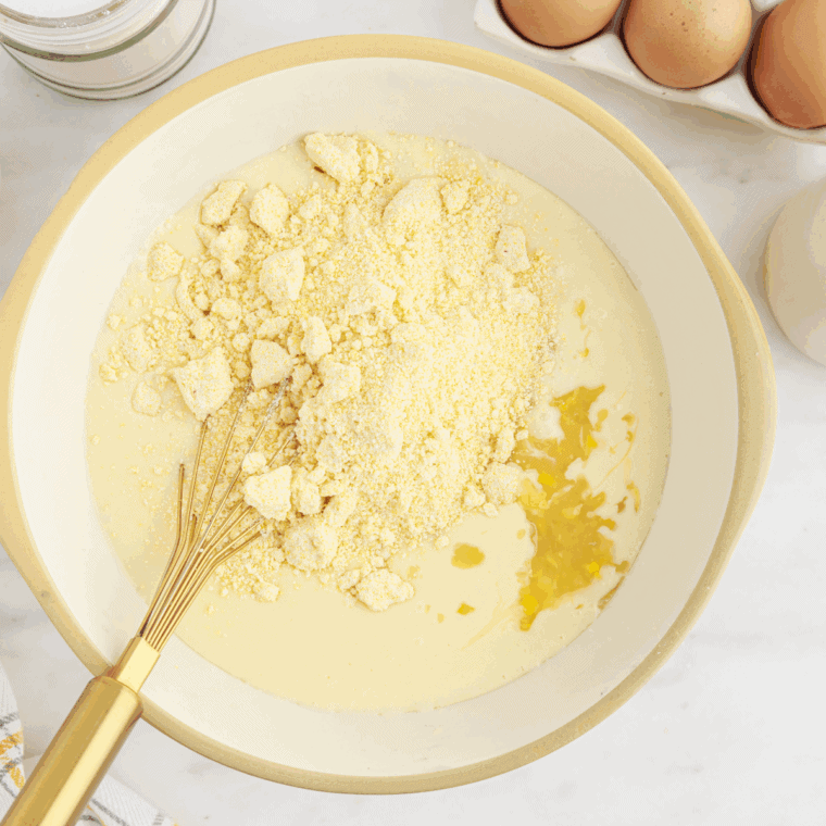Mix whole kernel corn, creamed corn, Jiffy mix, sour cream, melted butter, sugar, and eggs in large bowl.