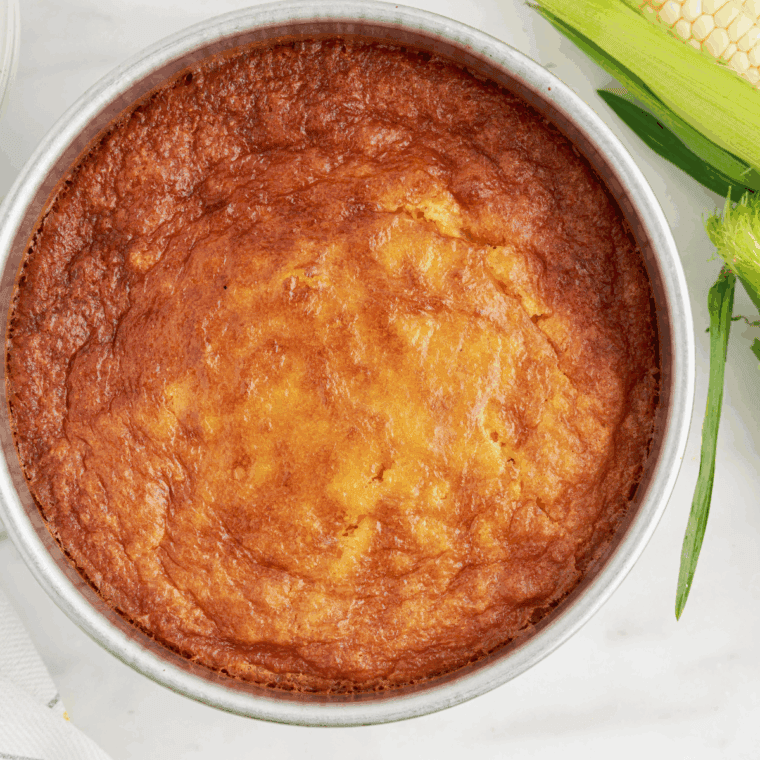 Golden, creamy corn casserole sliced and ready to serve.