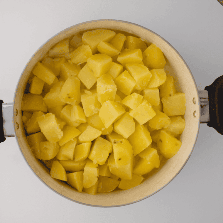 Boil the potatoes until fork tender.