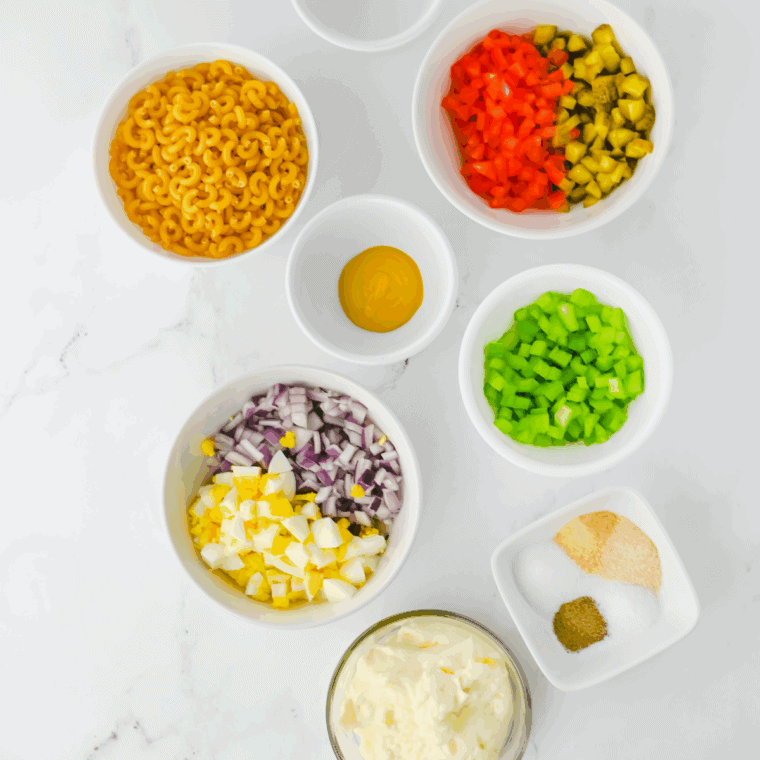 Ingredients needed for Gordon Ramsay Macaroni Salad Recipe on kitchen table.
