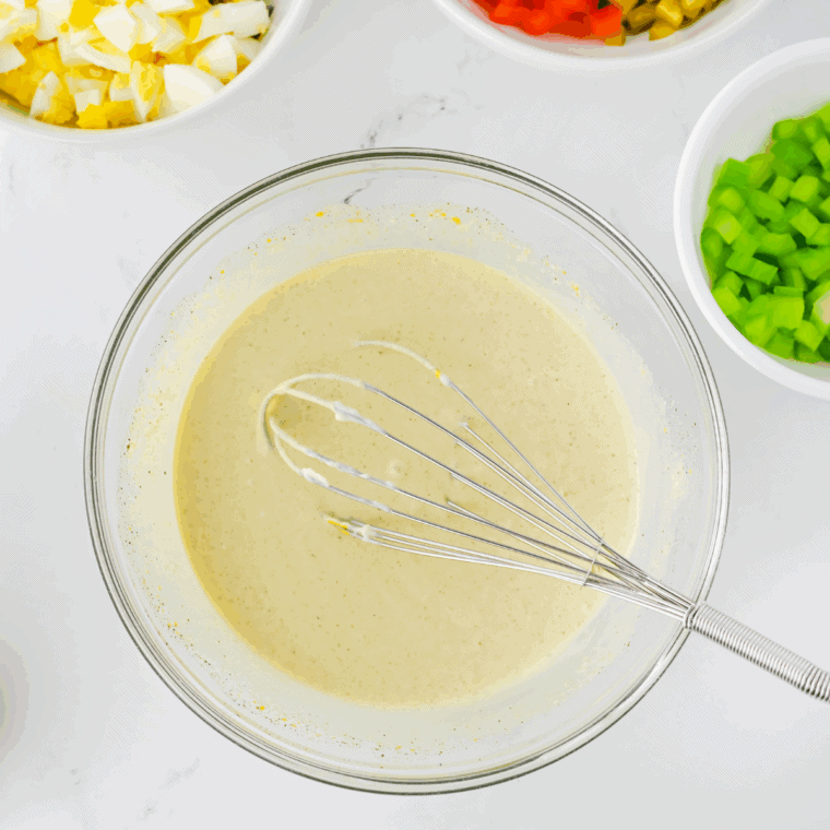Mayonnaise, Dijon mustard, and white wine vinegar whisked together in a bowl until smooth.