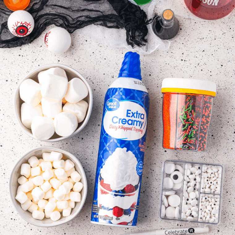 Ingredients needed for Halloween Hot Cocoa Whipped Cream on kitchen table.
