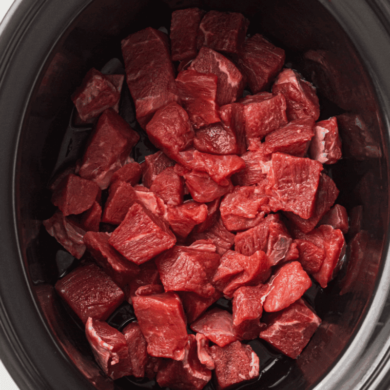 Searing seasoned beef strips in hot olive oil until golden brown.