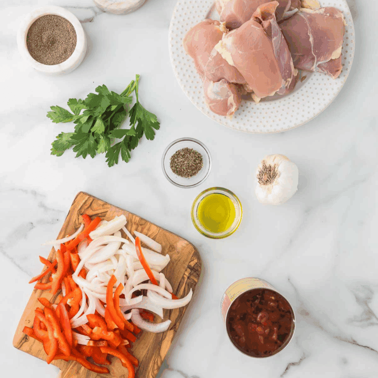 Ingredients needed for Easy Ina Garten's Chicken Cacciatore Recipe on kitchen table.
