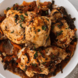 Easy Ina Garten Chicken Cacciatore with tender chicken simmered in tomato sauce, bell peppers, and herbs in a skillet.