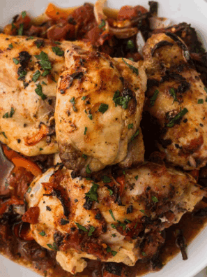 Easy Ina Garten Chicken Cacciatore with tender chicken simmered in tomato sauce, bell peppers, and herbs in a skillet.