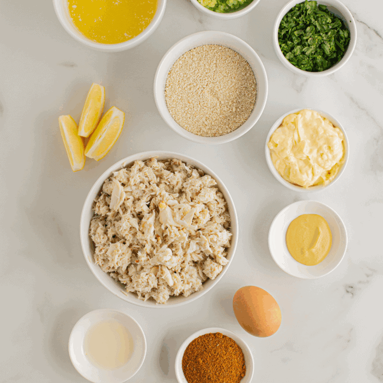 Ingredients needed for Ina Garten’s Crab Cakes Recipe on kitchen table.