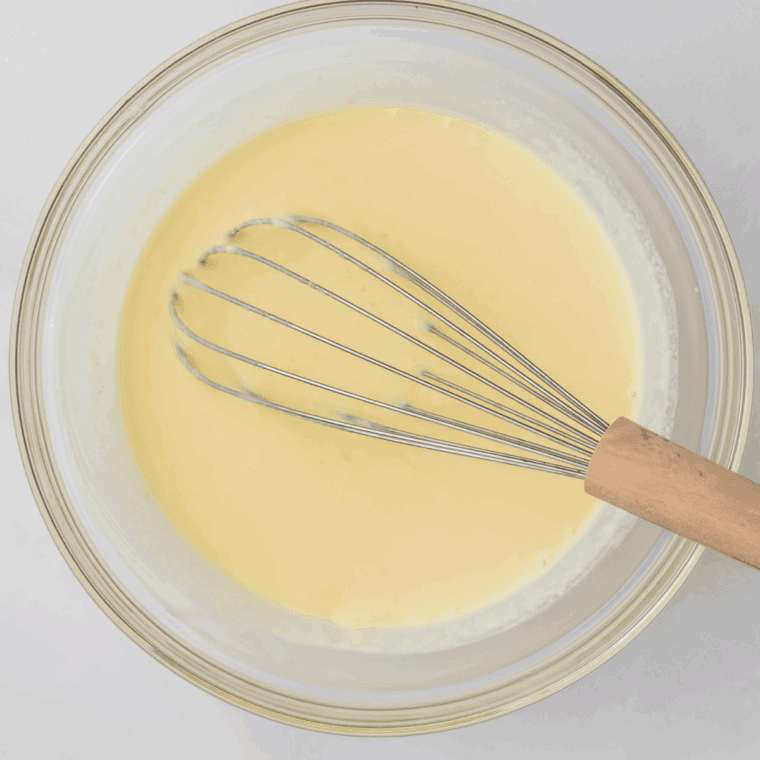 Sweetened condensed milk, vanilla, and cream mixture whisked until smooth in a medium bowl.