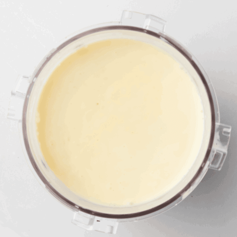 Ice cream base poured into a Ninja Creami pint container before freezing.