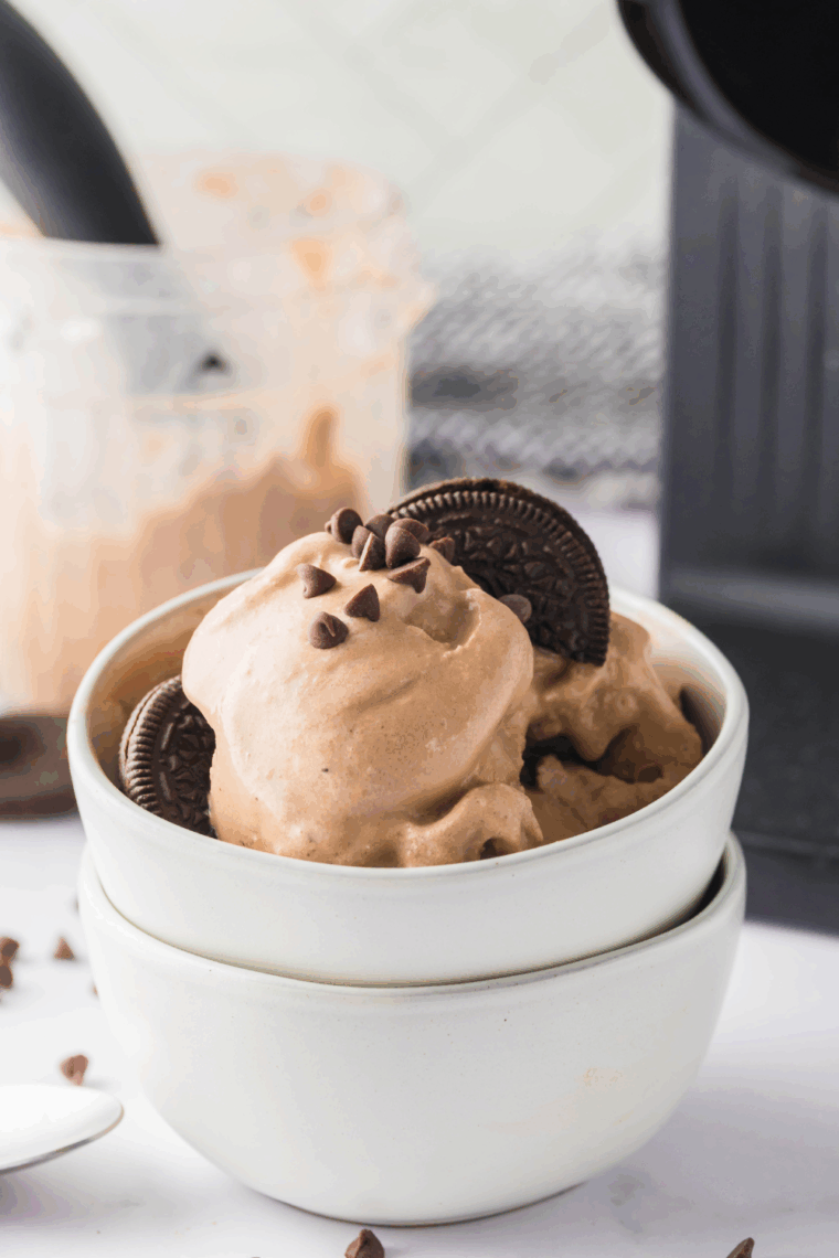 Homemade Ninja Creami Oreo Monkey Business ice cream in a bowl with chocolate swirls and Oreo cookie pieces.