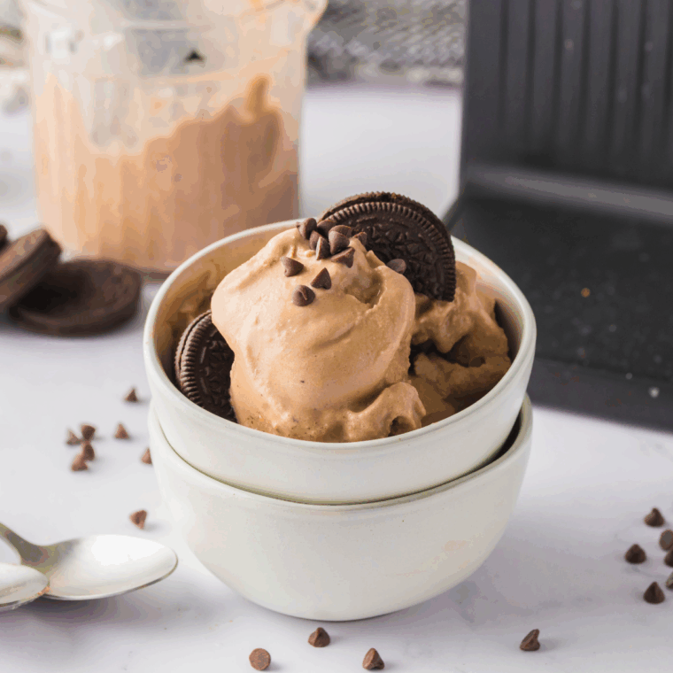 Ninja Creami Baskin Robbins Copycat Oreo Monkey Business ice cream with bananas, chocolate, and Oreo cookie pieces in a bowl.
