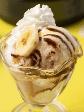 Homemade Ninja Creami Pralines n’ Cream ice cream with praline pieces and caramel swirls in a bowl.
