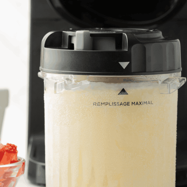 Processing the frozen base in the Ninja Creami machine using the ice cream setting.