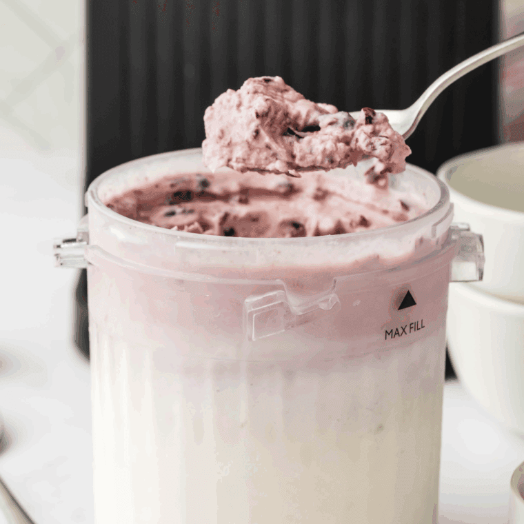 Homemade Ninja Creami Cherry Jubilee ice cream in a bowl, topped with juicy cherries.