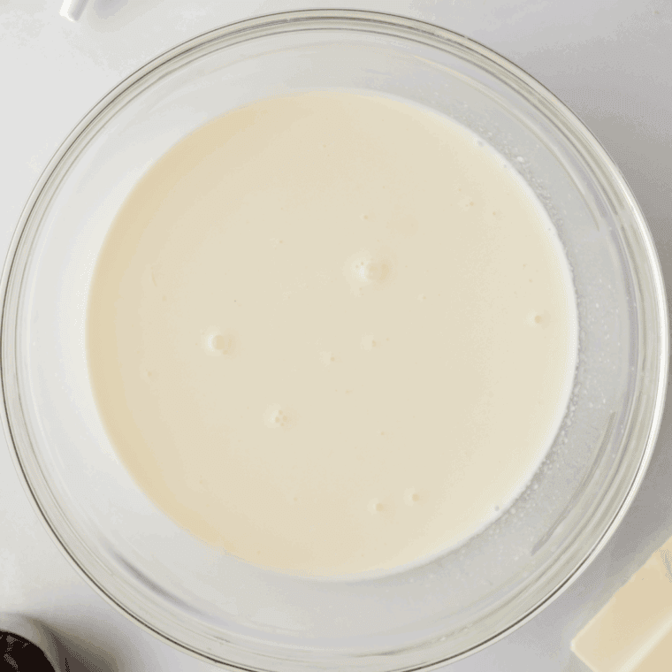 Mix granulated sugar, vanilla, and dry ice cream mix in a pint container, then whisk in milk and heavy cream until smooth. Add green food coloring for classic mint color.