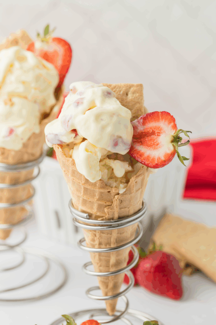Creamy Ninja Creami copycat Baskin Robbins Very Berry Strawberry Ice Cream served in a bowl with fresh strawberries on top.