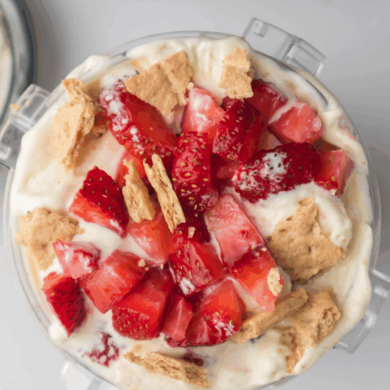 Bowl of creamy Ninja Creami Copycat Baskin Robbins Very Berry Strawberry Ice Cream topped with fresh strawberry slices.