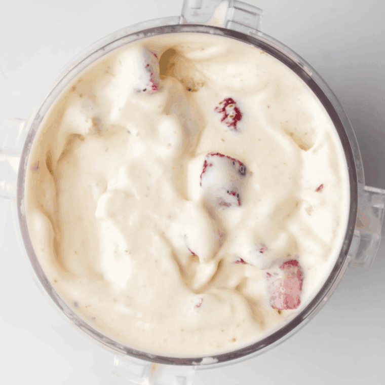 Processed ice cream scooped into bowls or cones, with optional mix-ins like extra strawberries or chocolate chips.