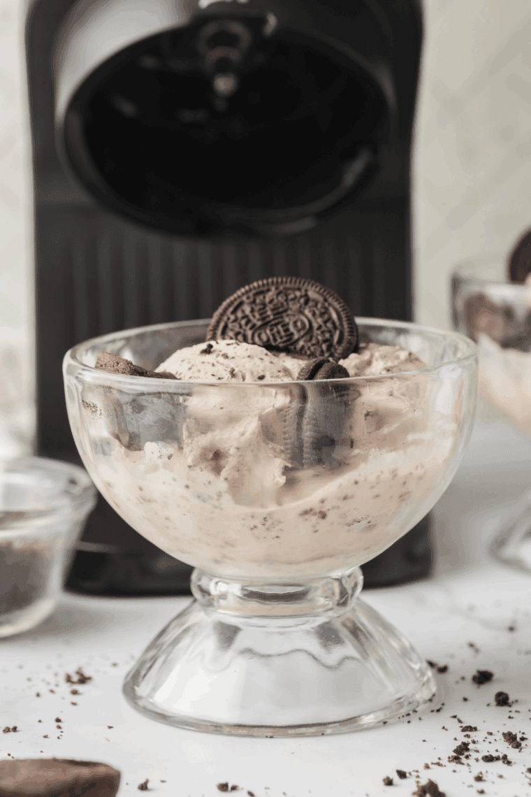 Ninja Creami Copycat Dairy Queen Oreo Fudge Brownie Blizzard — creamy ice cream swirled with crushed Oreos and gooey brownie chunks in a glass bowl.