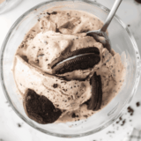 Homemade Ninja Creami Oreo Fudge Brownie Blizzard in a glass cup, topped with crushed Oreos and brownie chunks, ready to enjoy.