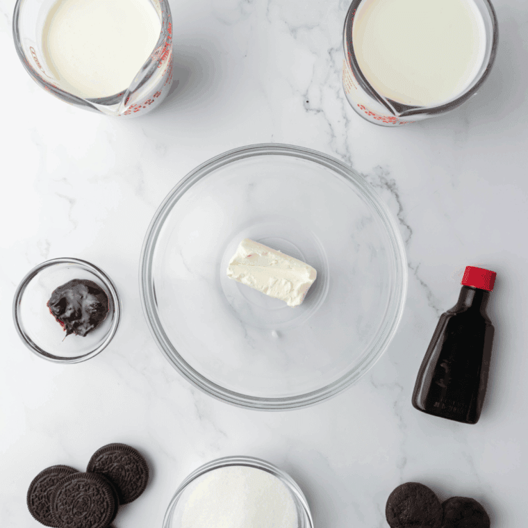 Ingredients needed for Ninja Creami Copycat Dairy Queen Oreo Fudge Brownie Blizzard on kitchen table.