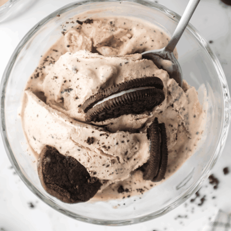 Homemade Ninja Creami Oreo Fudge Brownie Blizzard in a glass cup, topped with crushed Oreos and brownie chunks, ready to enjoy.