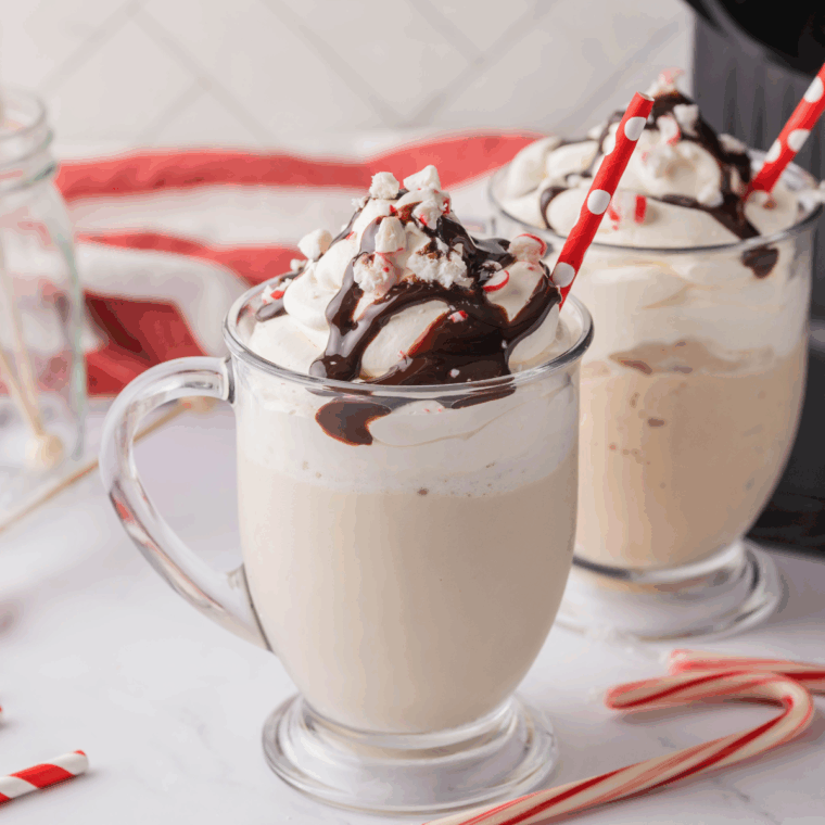 Ninja Creami Starbucks Peppermint Mocha Creamiccino in a glass topped with whipped cream, chocolate drizzle, and crushed peppermint candies.